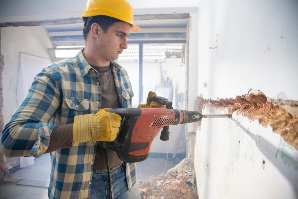 man drilling wall
